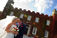 Wedding photograph of Luoise and Chris infront of Tregenna Castle Hotel, St Ives
