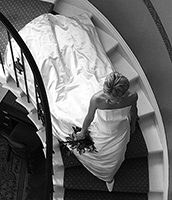 bride walking down stairs showing off her wedding dress