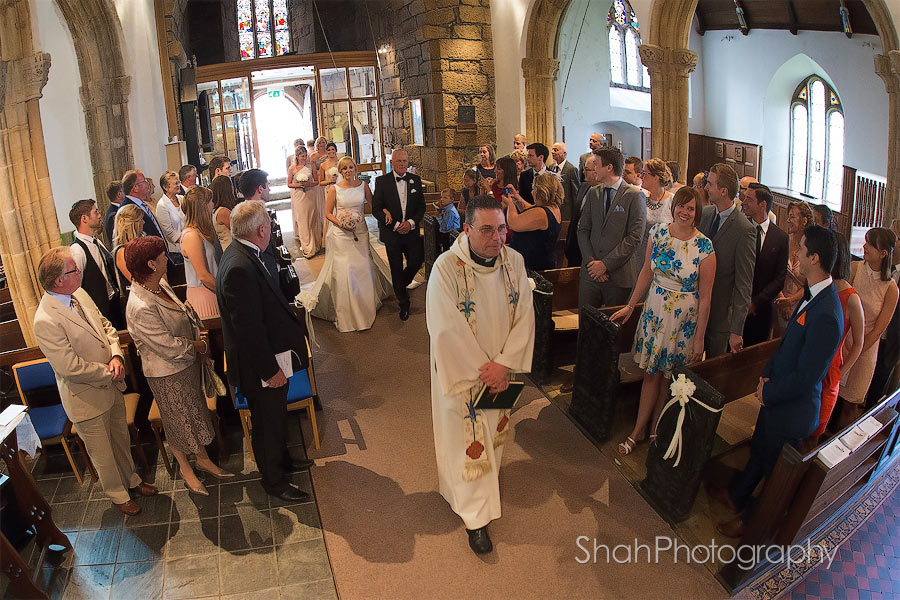 The bride walks down the aisle at St Ives Parish Church