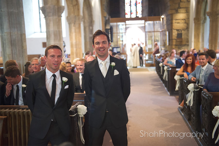 groom and best man wait for the bride to walk down the aisle