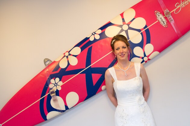 bride photographed against a surfboard