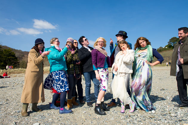 wedding guests photographed on a beach in Cornwall