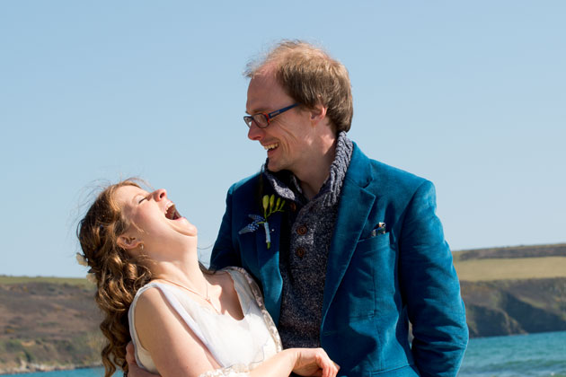 bride laughing during beach wedding photography 