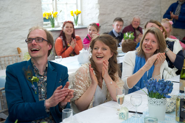 bride and groom laughing during the speeches at their wedding recption