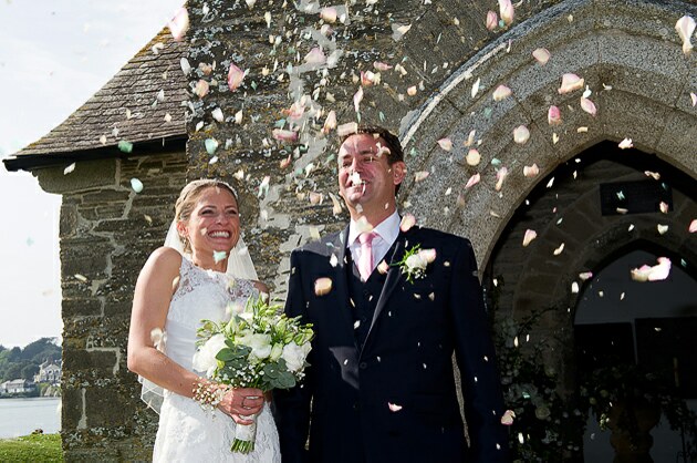 Confetti wedding photograph bride and groom outside church