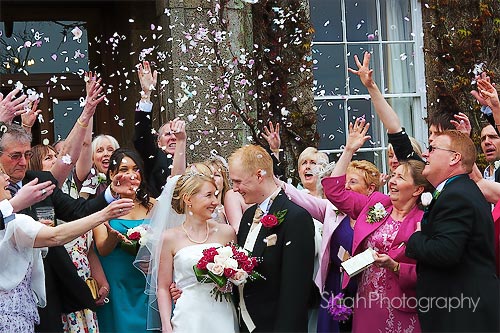 confetti being scattered over the newly weds 