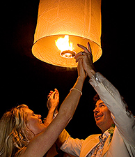 Lamorna and Andrew release a sky lantern during there wedding reception night