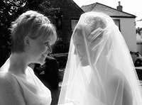 Bride and bridesmaid photographed before Sally's wedding ceremony at Paul Church