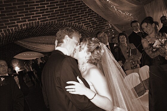 The wedding kiss features a warm toned photograph taken at Polhawn Fort