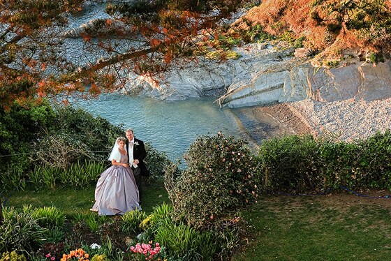 Bride and groom with the private beach accessible from Polhawn Fort