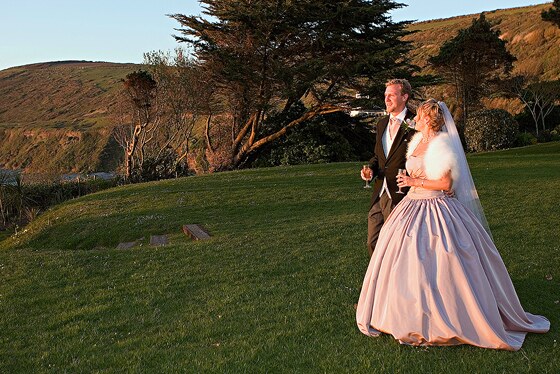 bride and groom in the grounds of Polhawn Fort with the setting sun providing fabulous light