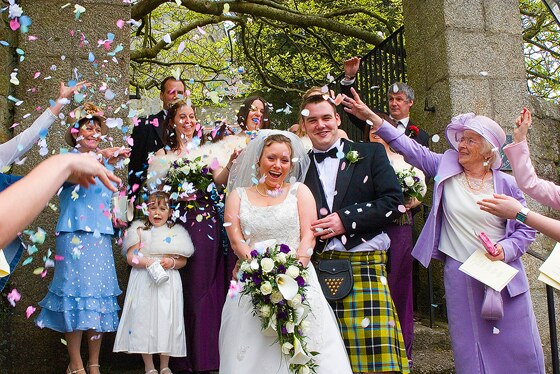 wedding photography Helston shows bride and groom being showered with confetti