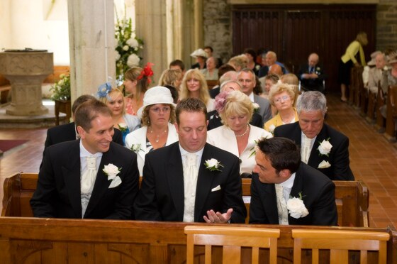 The groom and best man in the church ready for the wedding ceremony