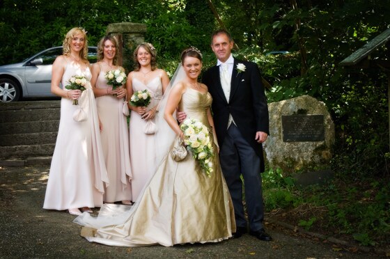 The bride and father of the bride arrive with the bridesmaids at Lanteglos Church