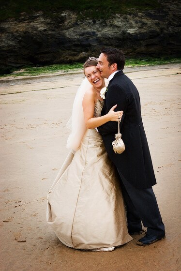 Bride and groom enjoying a beach photo session during their wedding day