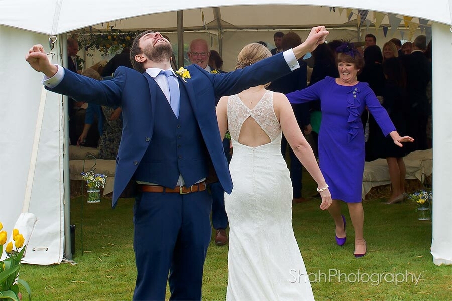 The groom's joy and relief after the wedding ceremony in Cornwall. Reportage wedding photography by Cornwall wedding photographer