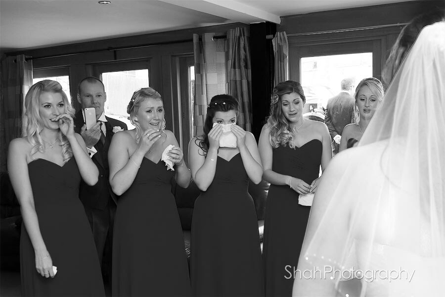 Bridesmaids reaction to first sight of the bride in her wedding dress