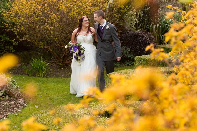 natural photograph as bride walks in the grounds of Tregenna Castle with her groom