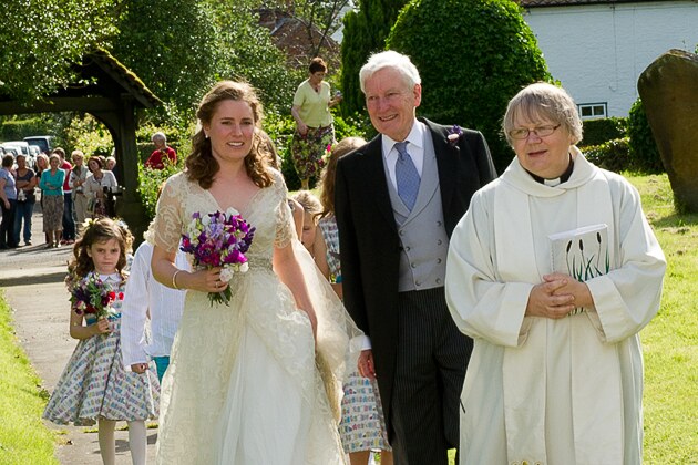 the arrival of the bridal party led by the vicar