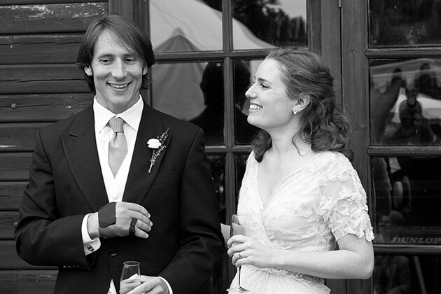 relaxed bride and groom smiling during the speeches