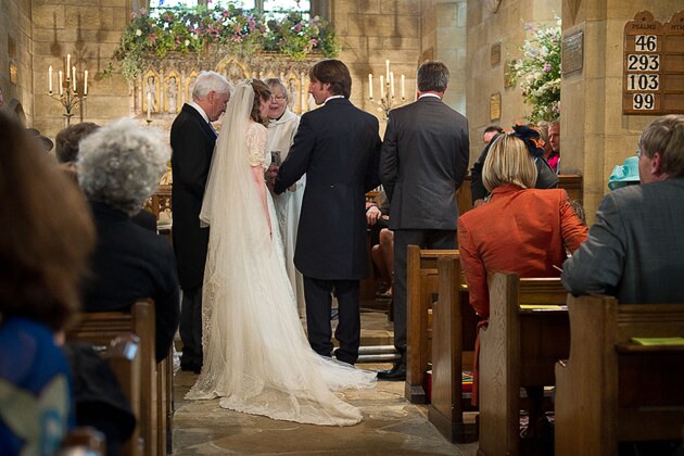 brides father gives his daughter's hand to the groom just before the couple take their vows