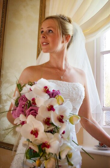 Bride with her bouquet designed by wedding flowers in Cornwall. Photo: Shah Photography