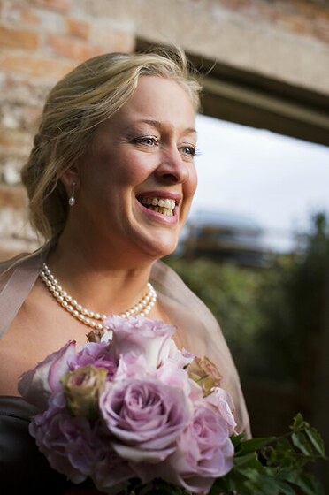 Bride Natalie with her wedding flowers by Anna photo Shah Photography